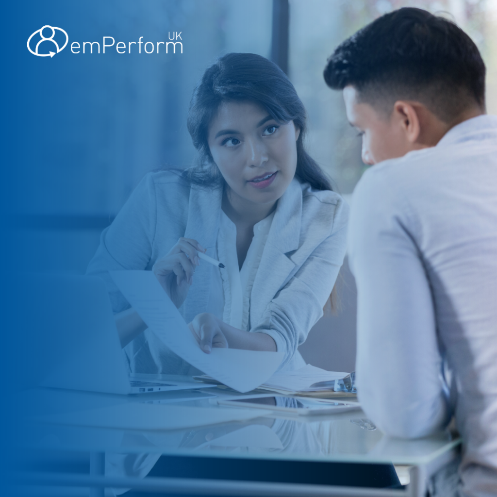 woman and man speaking at an employee review