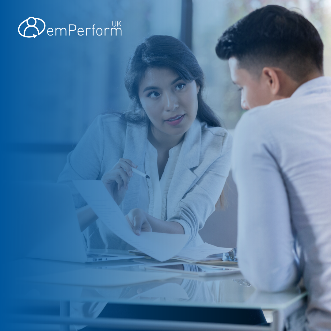 woman and man speaking at an employee review